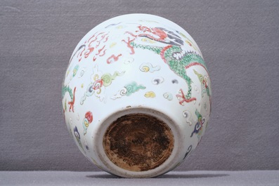 A Chinese blue and white fish bowl and a famille rose 'dragon' jardini&egrave;re, 19th C. and Yongzheng